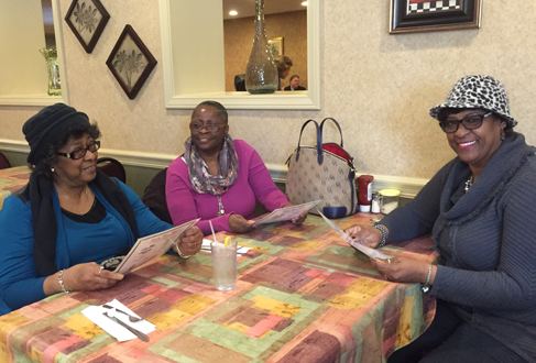Three women friends smiling and having lunch at Ricardo’s Restaurant in Erie, PA.